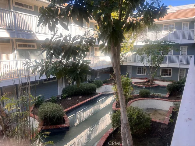 a view of a balcony with plants and a patio