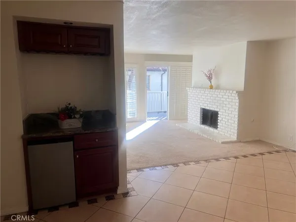 a view of a livingroom with wooden cabinets