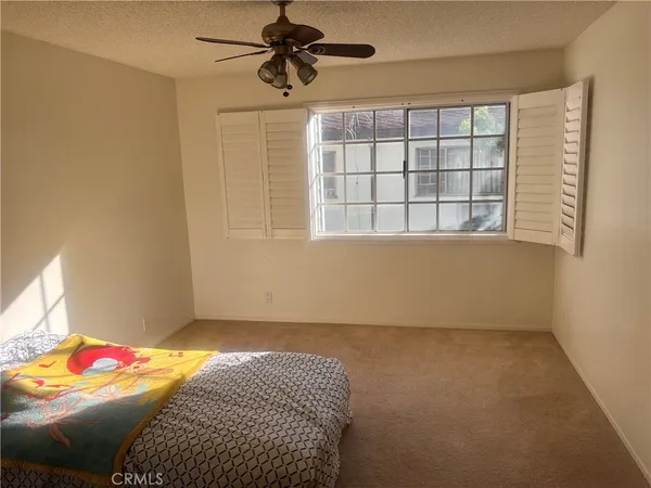 a bedroom with a bed and a window