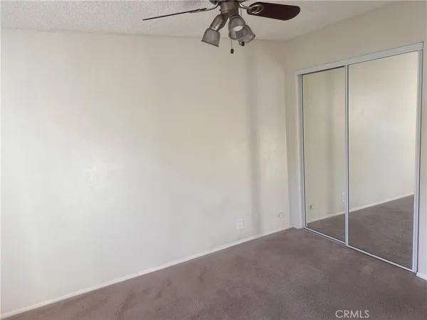 a view of a room with a ceiling fan