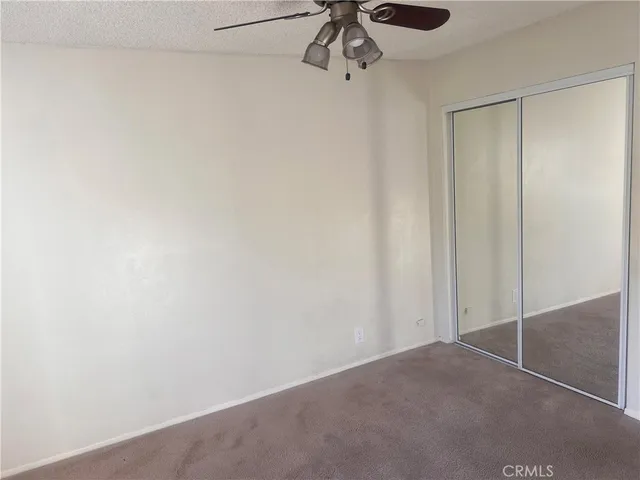 a view of a room with a ceiling fan