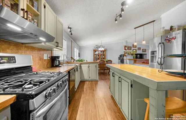 a kitchen with stainless steel appliances granite countertop a stove and a sink