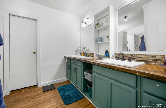 a kitchen with a sink and a wooden floor