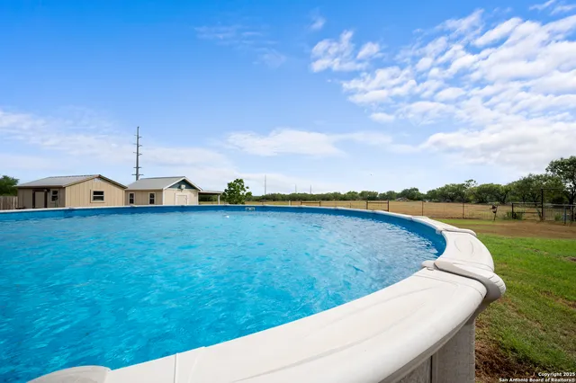 a view of a swimming pool with a yard
