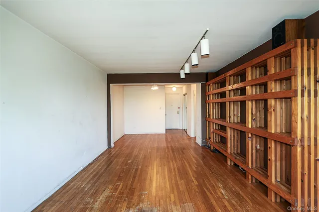a view of empty room with wooden floor
