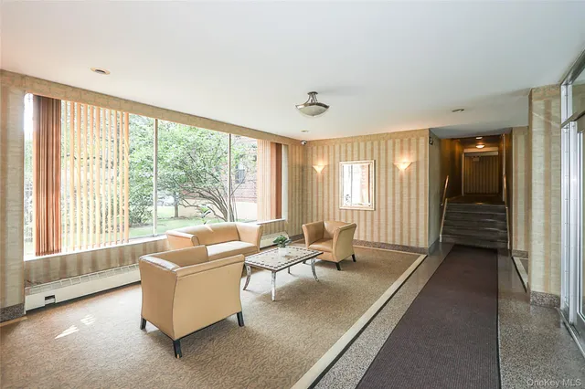 a living room with furniture and large windows