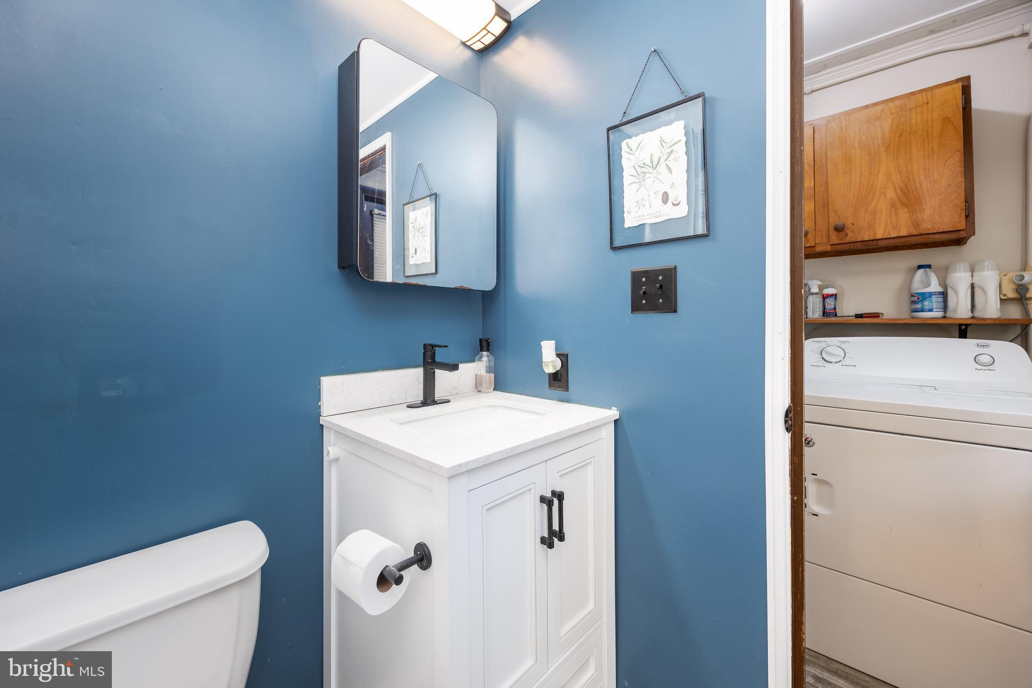 26467 Mariners Road Crisfield, MD 21817 - Photo 30 of 44 a bathroom with a toilet a sink and mirror