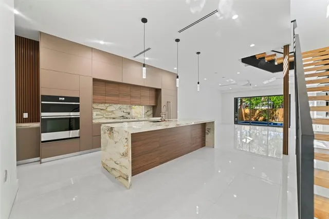 a view of kitchen with refrigerator stove and oven