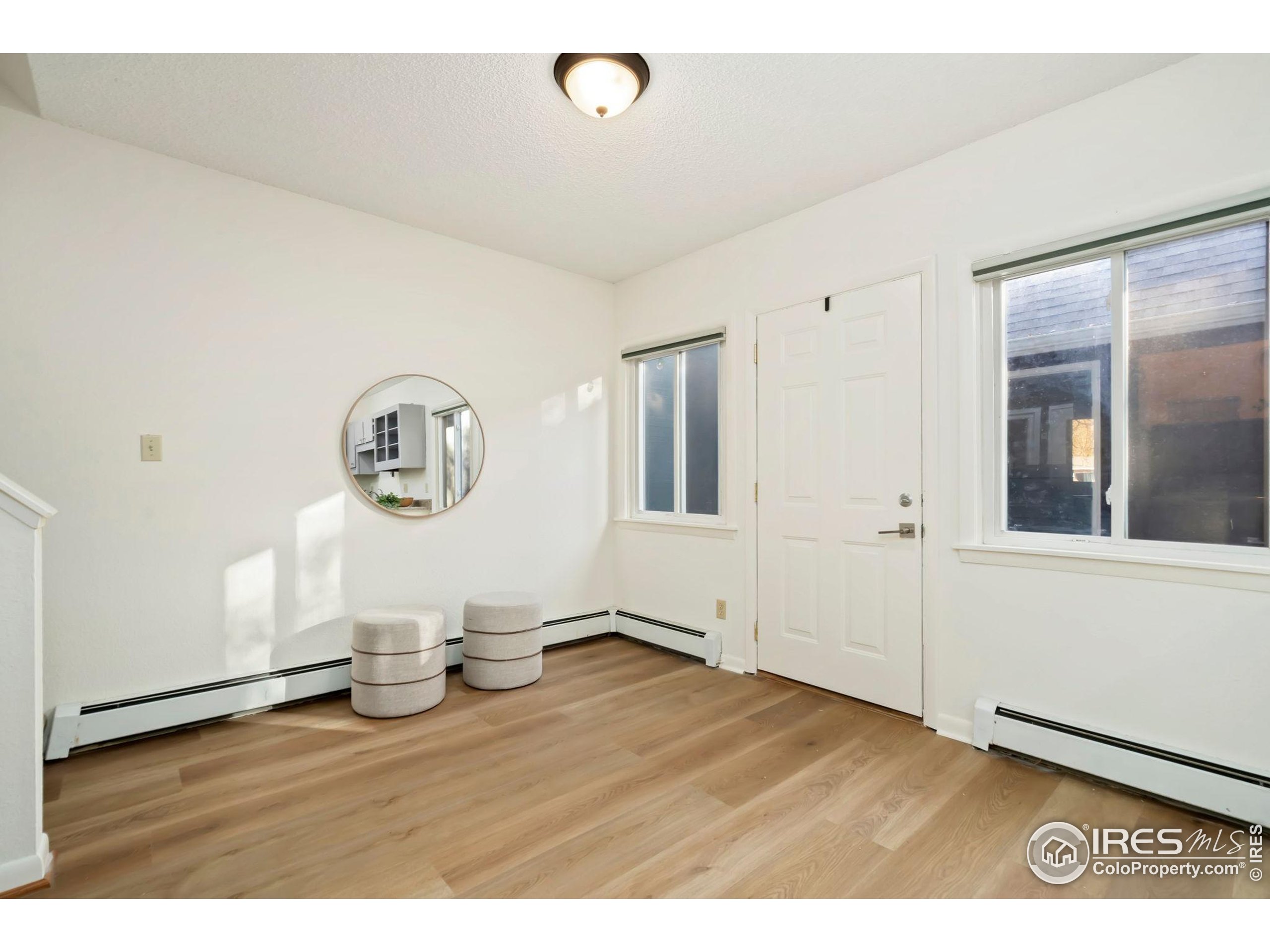 1737 Springmeadows Court, Unit A Fort Collins, CO 80525 - Photo 4 of 20 a view of empty room with wooden floor