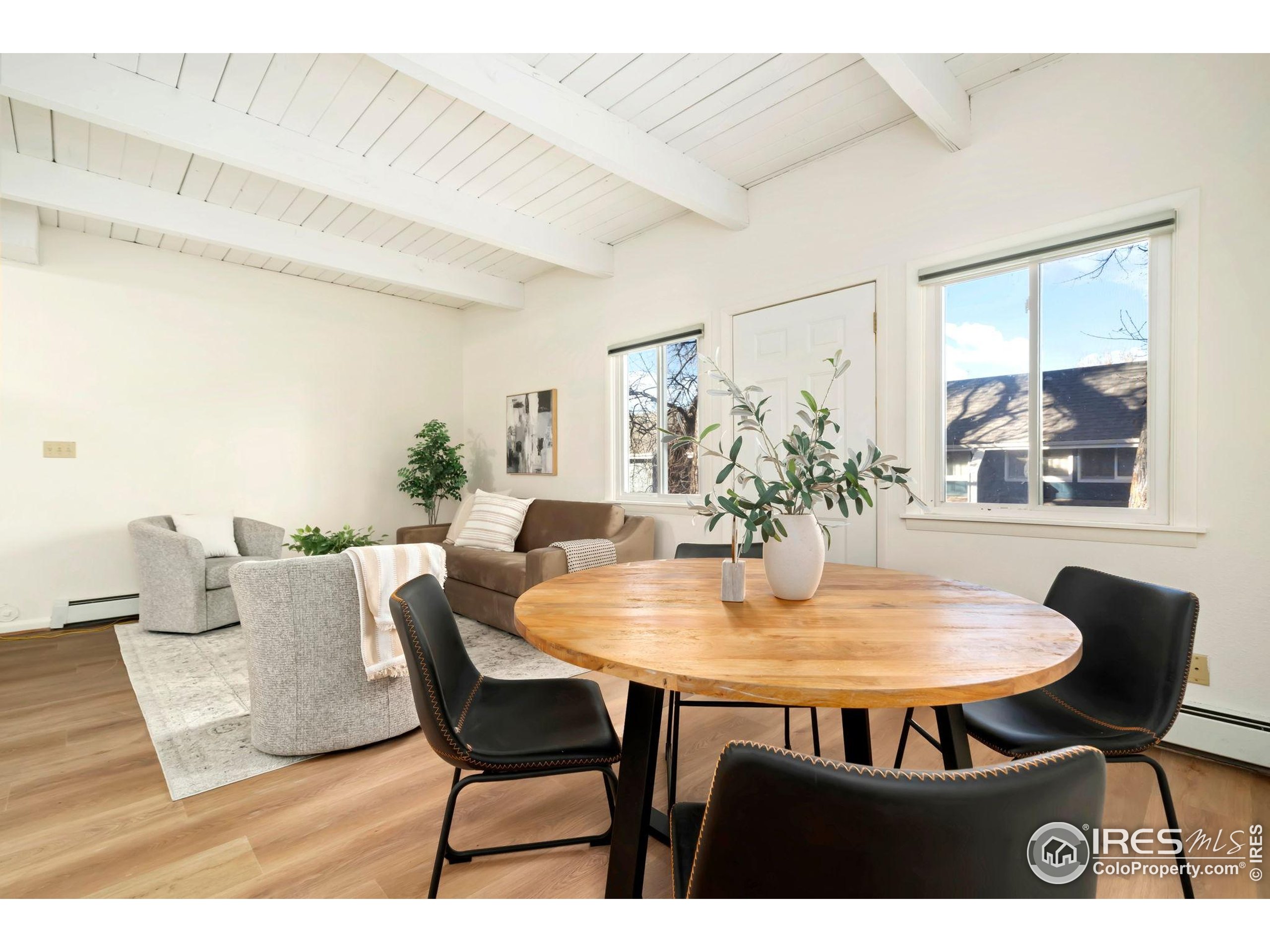 1737 Springmeadows Court, Unit A Fort Collins, CO 80525 - Photo 7 of 20 a view of a dining room with furniture and a potted plant