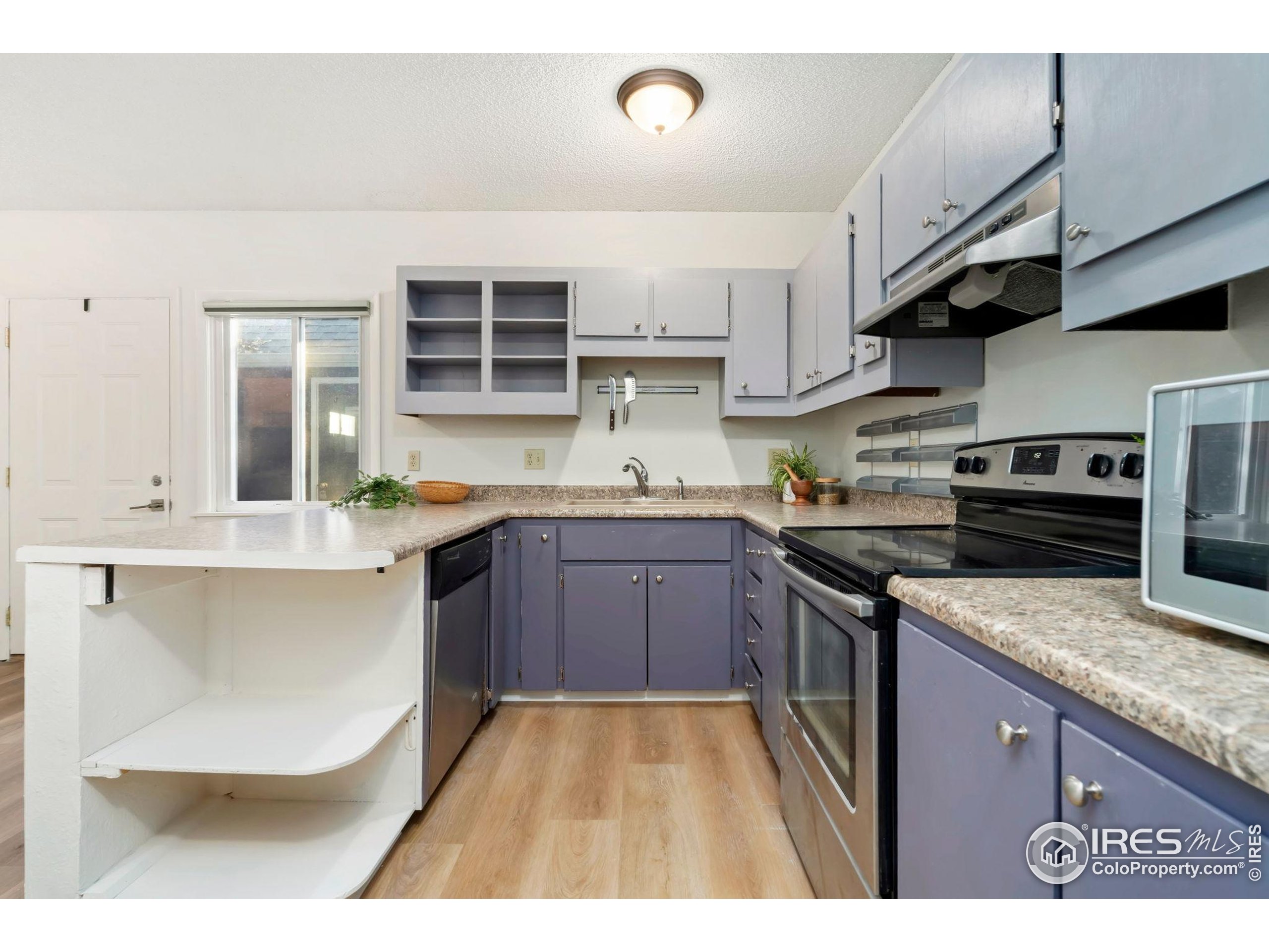 1737 Springmeadows Court, Unit A Fort Collins, CO 80525 - Photo 10 of 20 a kitchen with stainless steel appliances granite countertop a sink a stove and cabinets