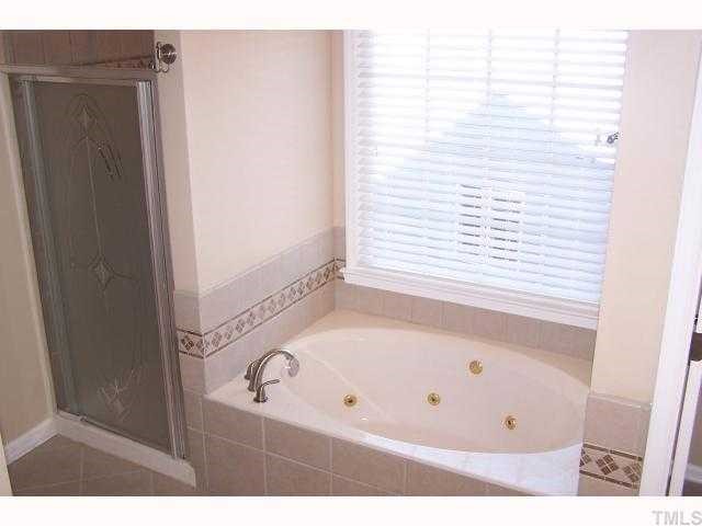 8829 Breeland Way Raleigh, NC 27613 - Photo 6 of 12 a bathroom with a bathtub