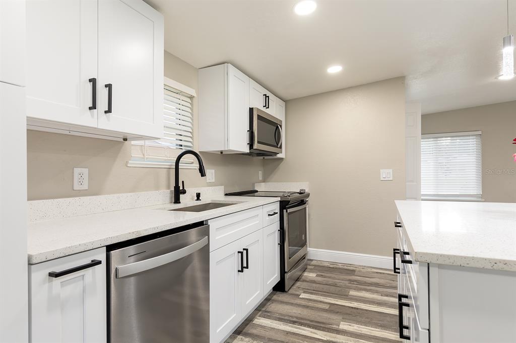 1007 San Domingo Road Orlando, FL 32808 - Photo 4 of 17 a kitchen with a sink and cabinets