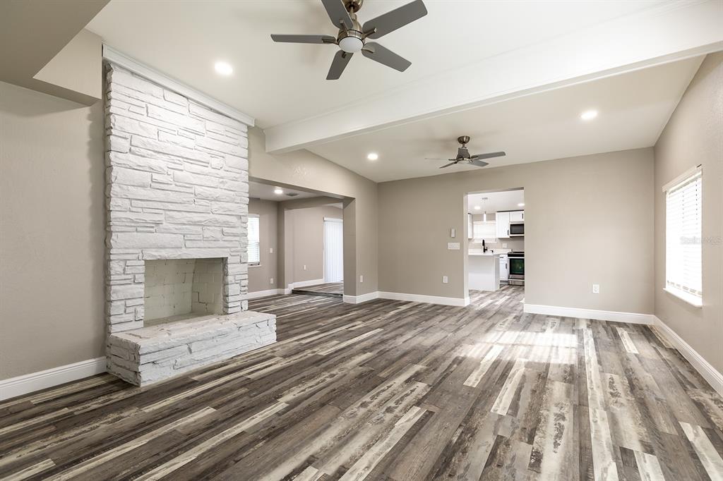1007 San Domingo Road Orlando, FL 32808 - Photo 5 of 17 a view of empty room with wooden floor and fan