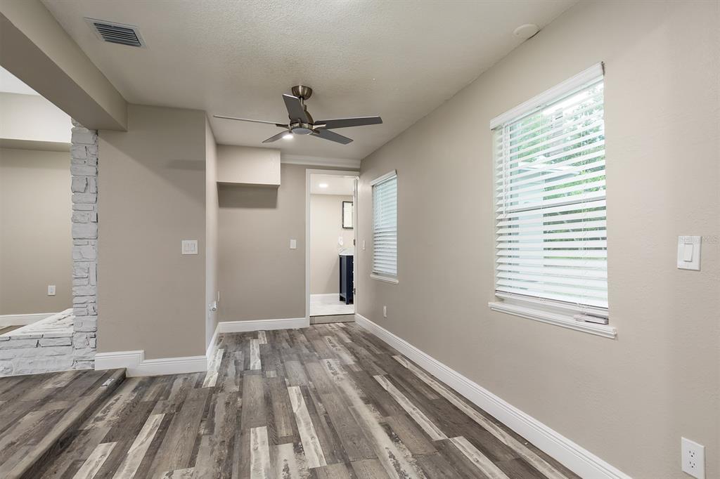 1007 San Domingo Road Orlando, FL 32808 - Photo 10 of 17 a view of an empty room with wooden floor and a window