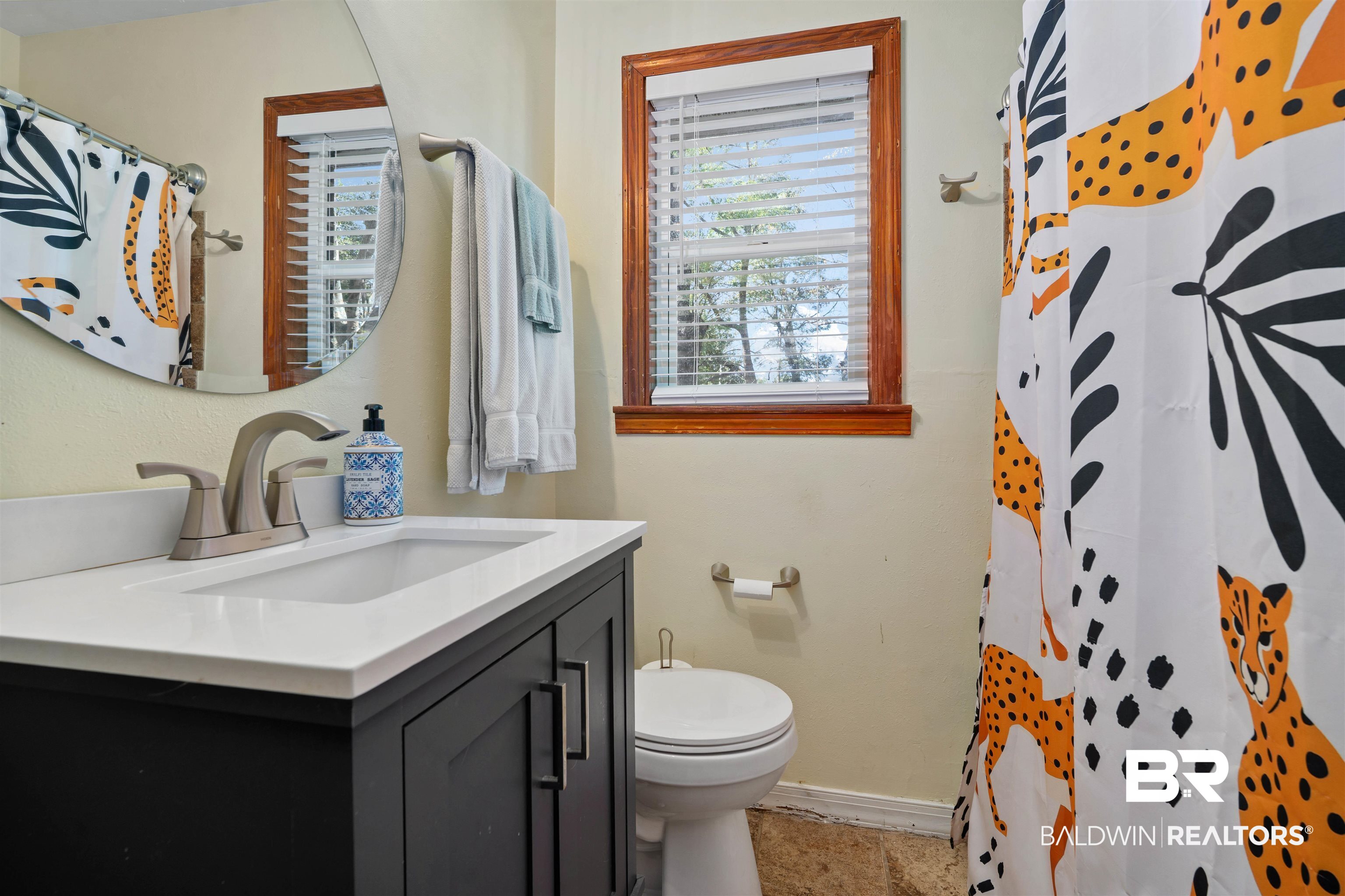 672 Tarawa Drive Mobile, AL 36609 - Photo 21 of 26 Full bathroom with curtained shower, vanity, and plenty of natural light