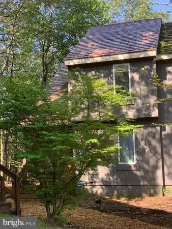 a small wooden house with a yard