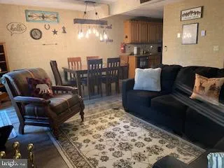 a living room with furniture and a rug