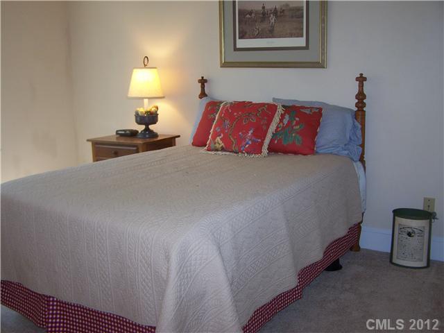 241 Kimberly Road Davidson, NC 28036 - Photo 11 of 16 a bedroom with a bed and a lamp