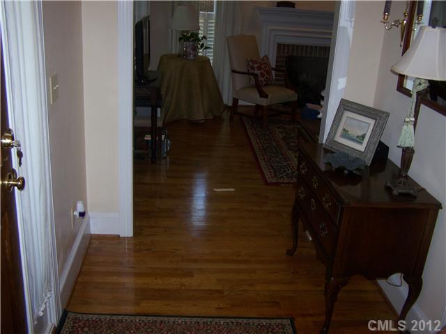 241 Kimberly Road Davidson, NC 28036 - Photo 3 of 16 a view of a hallway with wooden floor and stairs