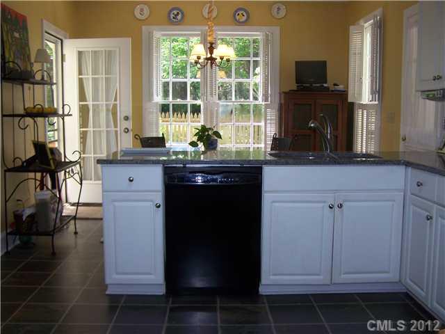 241 Kimberly Road Davidson, NC 28036 - Photo 6 of 16 a kitchen with stainless steel appliances granite countertop a stove a sink and a refrigerator