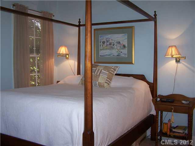 241 Kimberly Road Davidson, NC 28036 - Photo 8 of 16 a bedroom with a bed and a painting on the wall