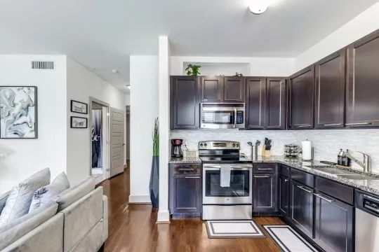a kitchen with stainless steel appliances a stove cabinets and a sink