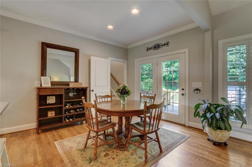 7772 Sutter Road Greensboro, NC 27455 - Photo 12 of 30 Breakfast area shows the hardwood floors, crown molding, recessed lighting and plantation shutters!