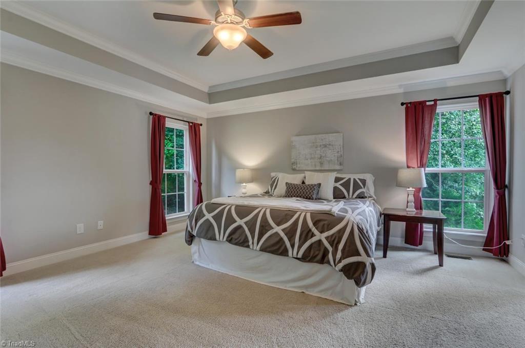 7772 Sutter Road Greensboro, NC 27455 - Photo 13 of 30 Spacious master on the main with tray ceiling! Great natural light and plenty of room for sitting area!