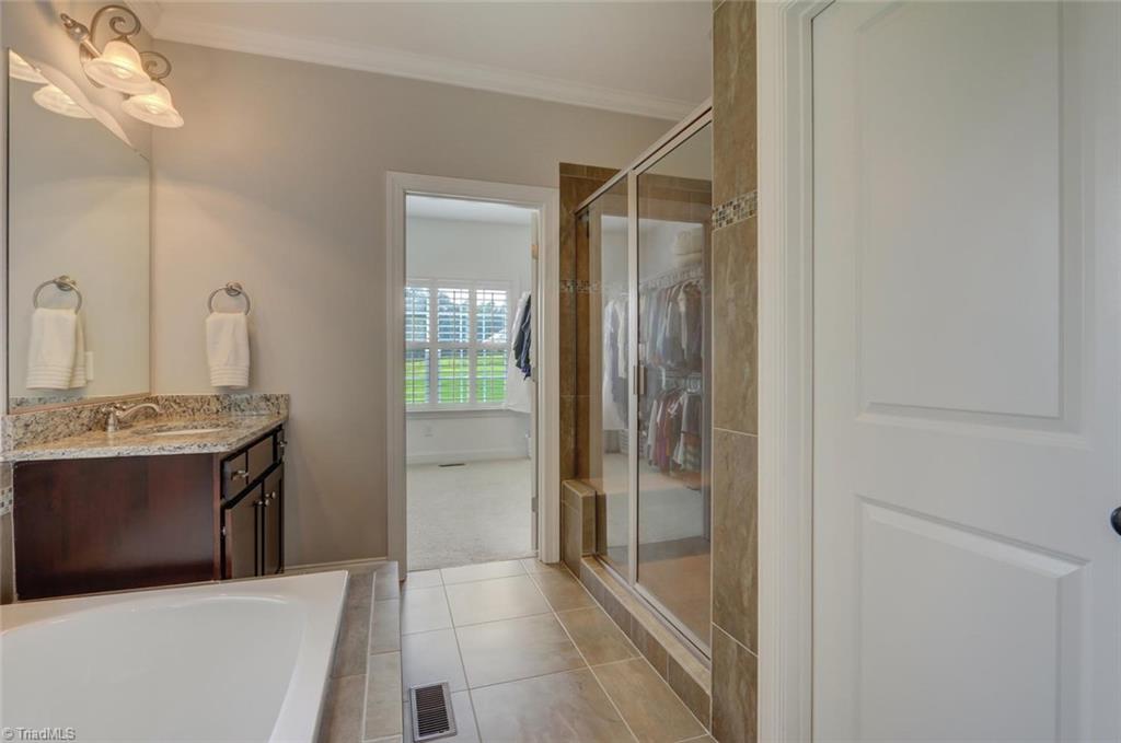 7772 Sutter Road Greensboro, NC 27455 - Photo 16 of 30 Master has a large walk-in shower and separate water closet.