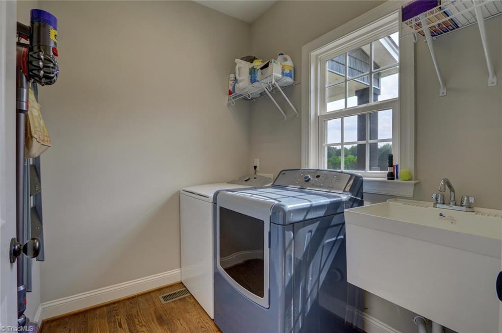 7772 Sutter Road Greensboro, NC 27455 - Photo 17 of 30 Main level laundry room off of welcome center area. Utility sink!