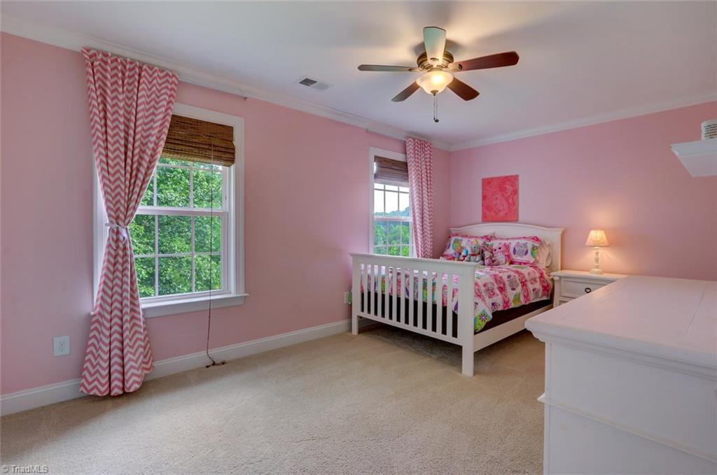7772 Sutter Road Greensboro, NC 27455 - Photo 19 of 30 Extra sweet! Large bedroom with double windows, walk-in closet, crown molding and ceiling fan.