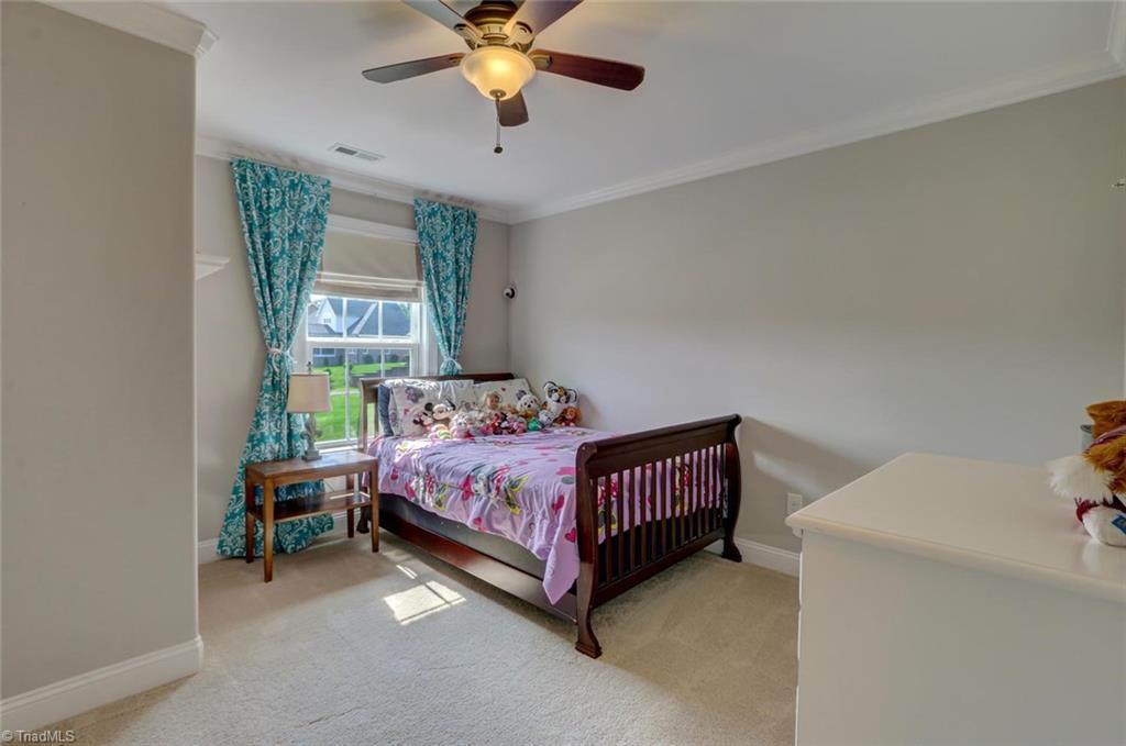 7772 Sutter Road Greensboro, NC 27455 - Photo 20 of 30 Each bedroom has a ceiling fan, crown molding and walk-in closet.
