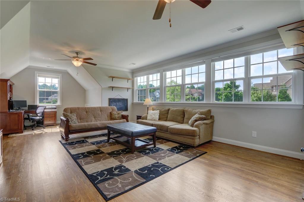 7772 Sutter Road Greensboro, NC 27455 - Photo 22 of 30 WOW!!! This beautiful bonus room is being used as a multi-purpose room. Fantastic light, double fans and full attached bath! Located over the 3 car garage!