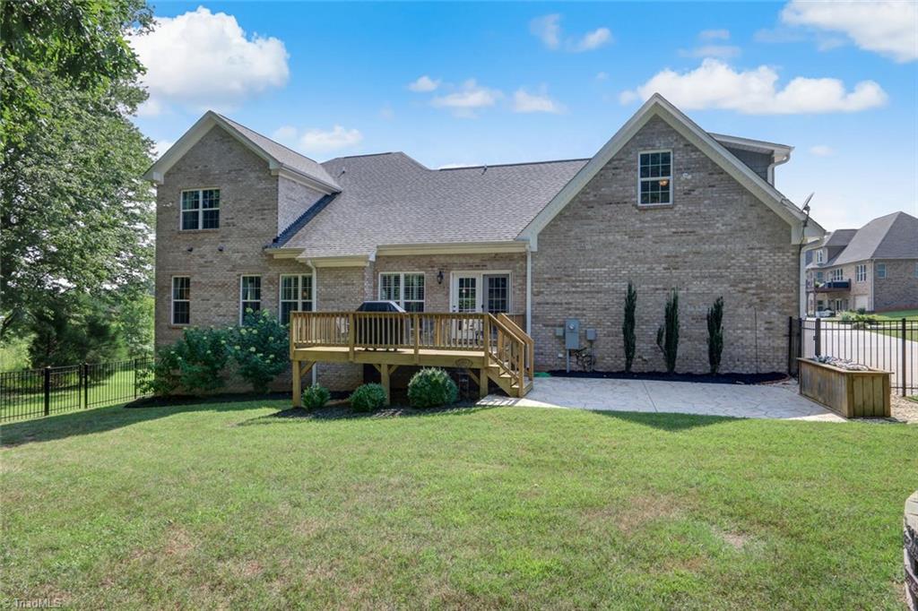 7772 Sutter Road Greensboro, NC 27455 - Photo 25 of 30 WOW!!! Outdoor living is at its best with this home! Paved stamped concrete patio with deck and planter just to start in the fenced backyard!