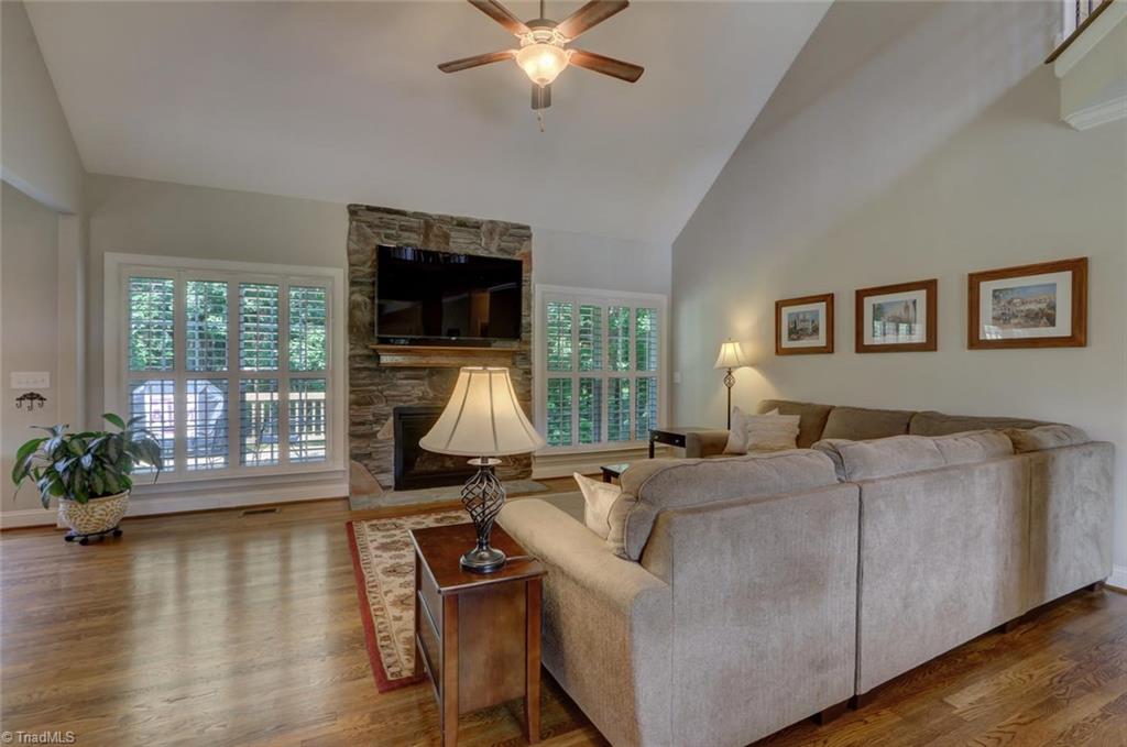 The stone gas log fireplace is a wonderful custom detail and offers a warm inviting feeling in this great room. 