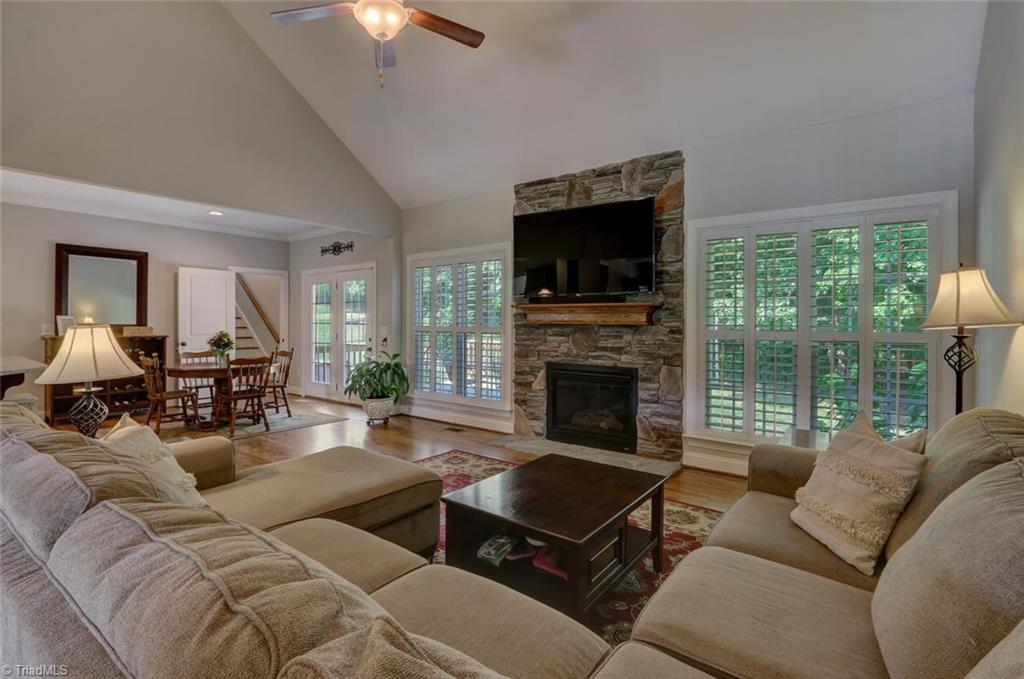 View from great room towards breakfast area and door that leads to fenced backyard and paved patio. Stairway leads to HUGE bonus with full bath over the garage! 