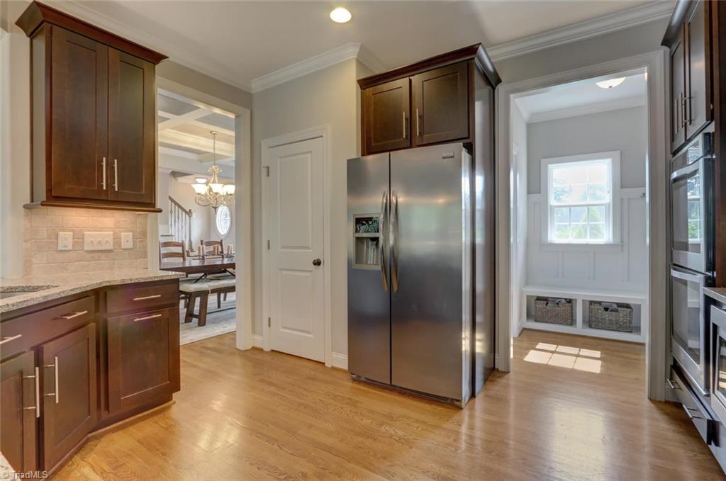 7772 Sutter Road Greensboro, NC 27455 - Photo 9 of 30 Pantry, under counter lighting, recessed refrigerator and view to the welcome center/mud room coming in from 3 car garage.