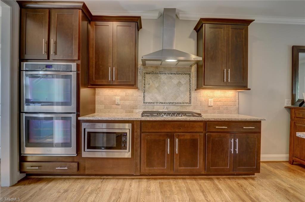 7772 Sutter Road Greensboro, NC 27455 - Photo 10 of 30 Double ovens!!! Gas cook top and built-in microwave all add to the many details in this home!