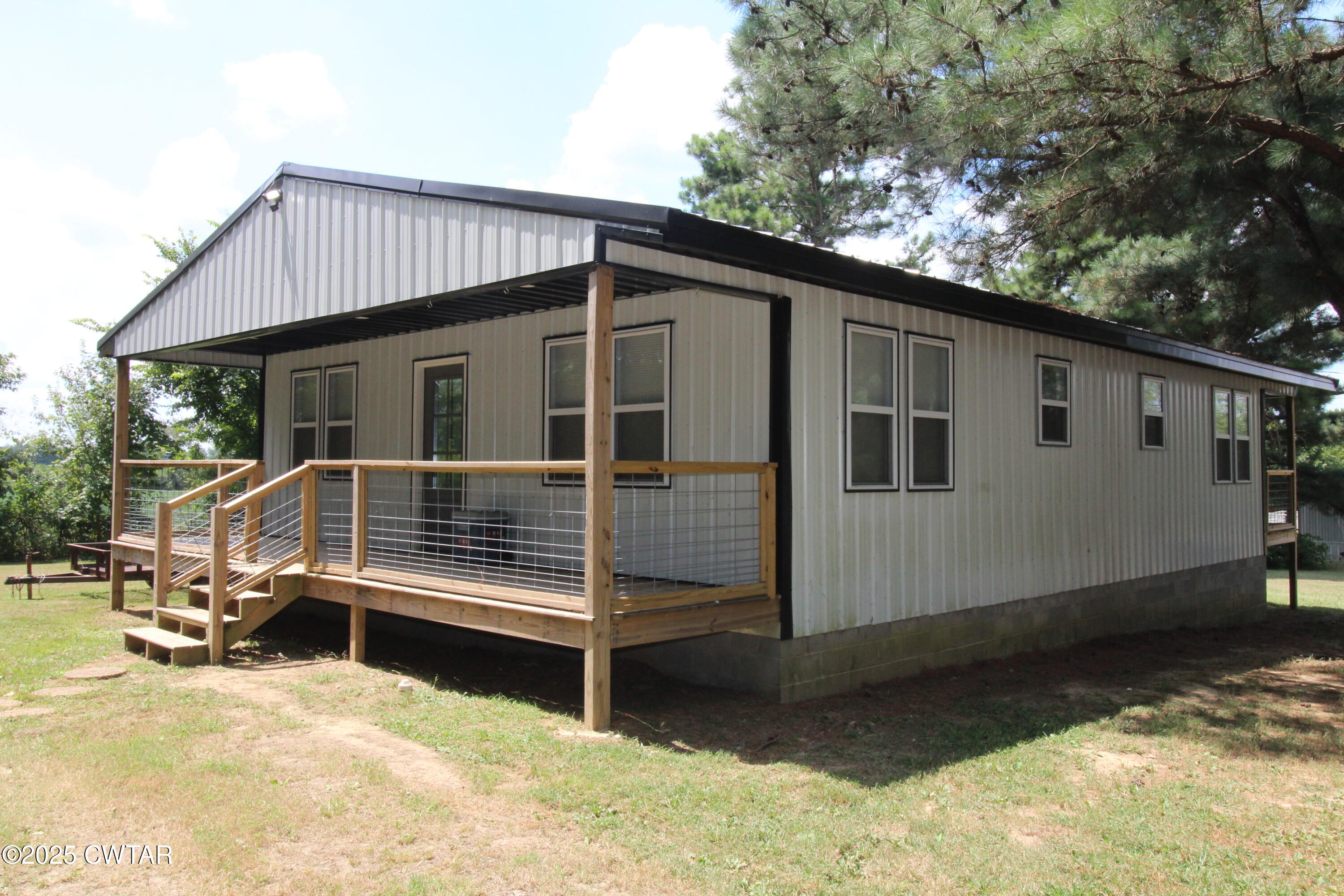 2983-2985 Sidonia Road Sharon, TN 38255 - Photo 1 of 4 a view of a house with a wooden roof deck
