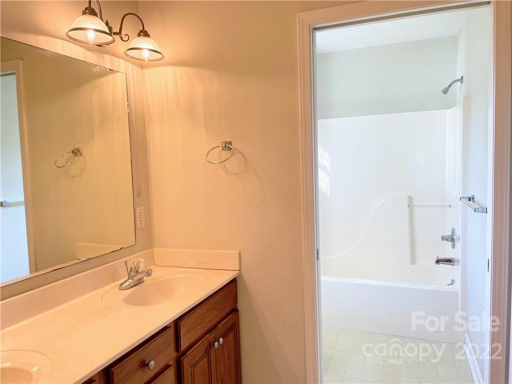 181 Hunters Trace Rutherfordton, NC 28139 - Photo 12 of 15 a bathroom with a granite countertop sink and a mirror