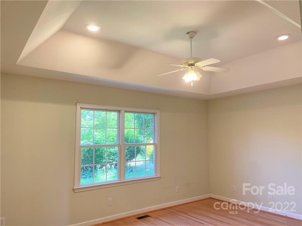 181 Hunters Trace Rutherfordton, NC 28139 - Photo 13 of 15 a view of an empty room with window and wooden floor