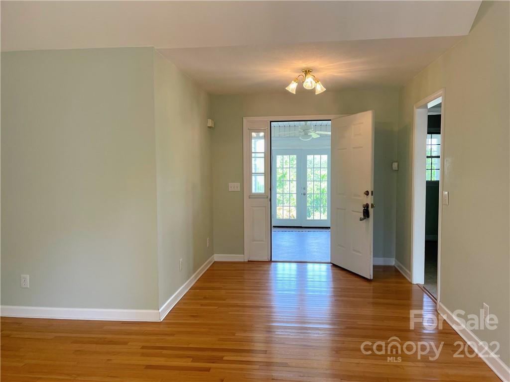 181 Hunters Trace Rutherfordton, NC 28139 - Photo 3 of 15 a view of an empty room with window and wooden floor