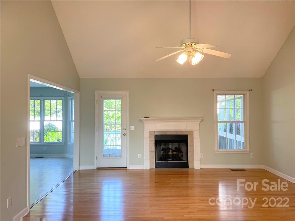 181 Hunters Trace Rutherfordton, NC 28139 - Photo 4 of 15 a view of an empty room with wooden floor and a window