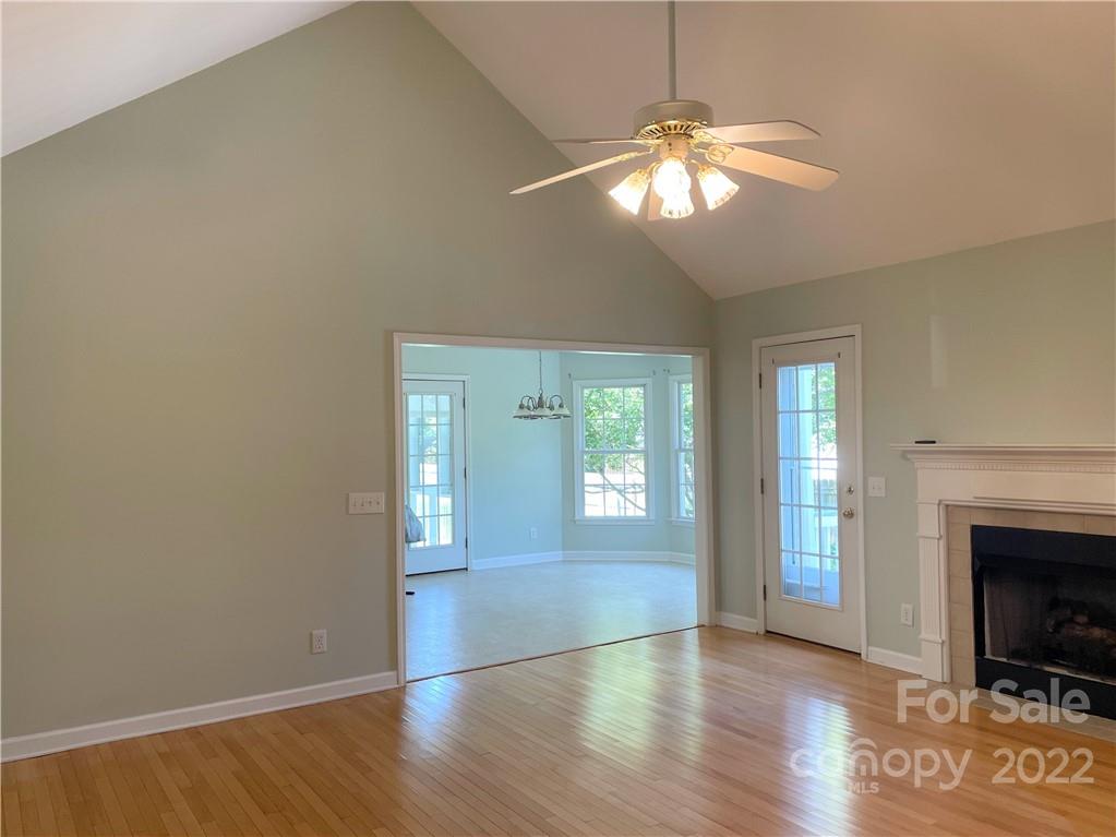 181 Hunters Trace Rutherfordton, NC 28139 - Photo 5 of 15 a view of an empty room with wooden floor and a fireplace