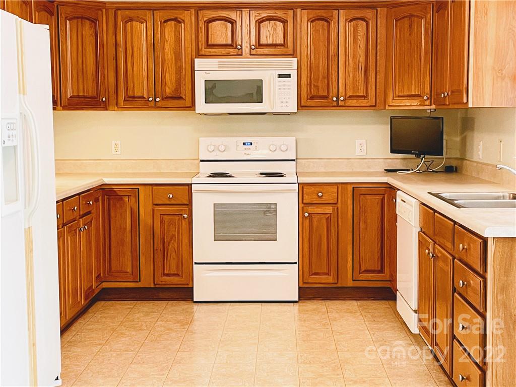 181 Hunters Trace Rutherfordton, NC 28139 - Photo 6 of 15 a kitchen with stainless steel appliances granite countertop a stove a sink and a microwave