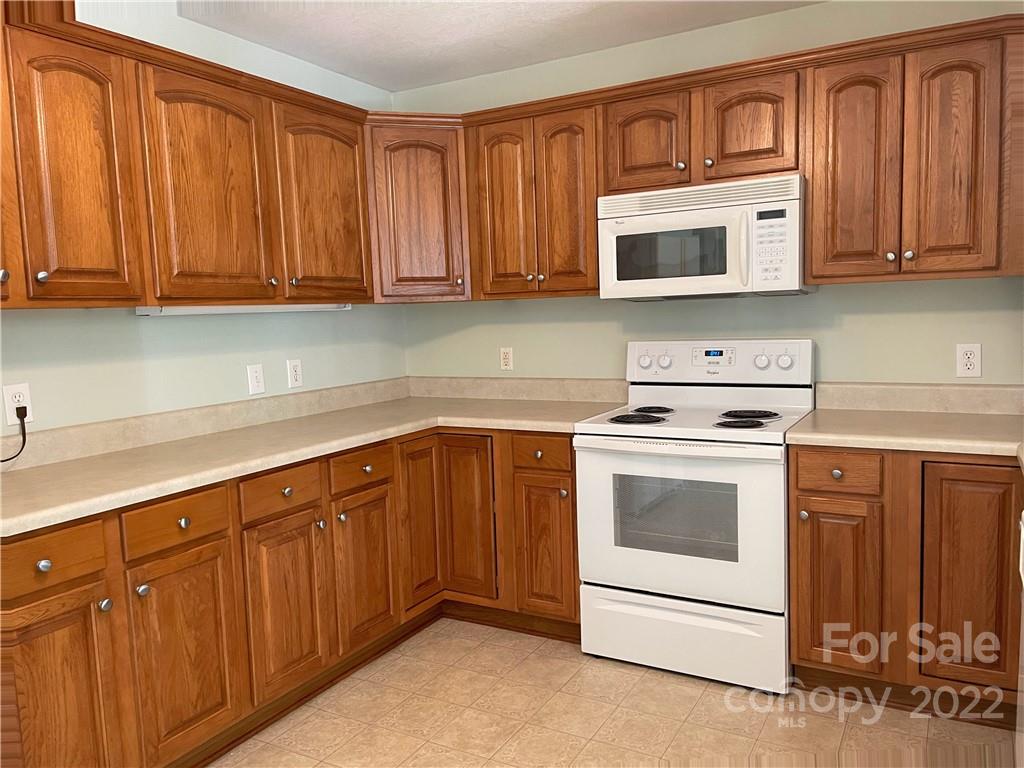 181 Hunters Trace Rutherfordton, NC 28139 - Photo 8 of 15 a kitchen with stainless steel appliances granite countertop a stove microwave and oven
