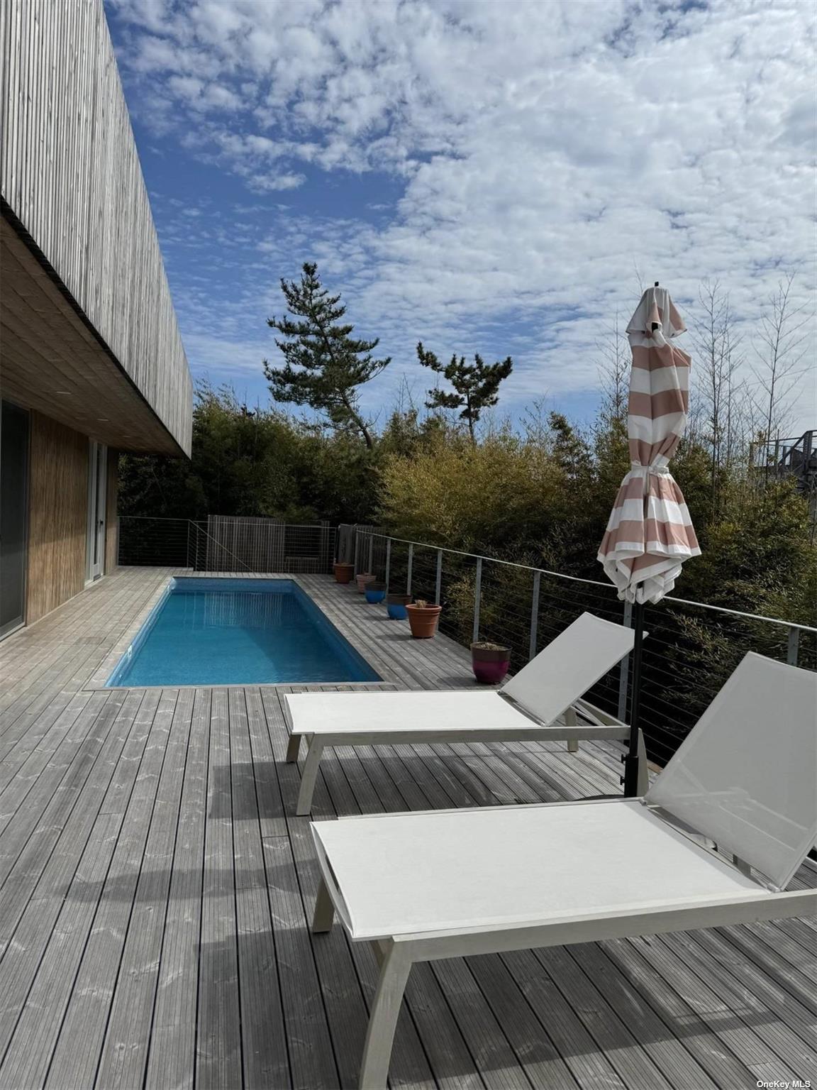 25 Sloop Walk Ocean Beach, NY 11770 - Photo 11 of 11 a view of roof deck with wooden floor and seating space