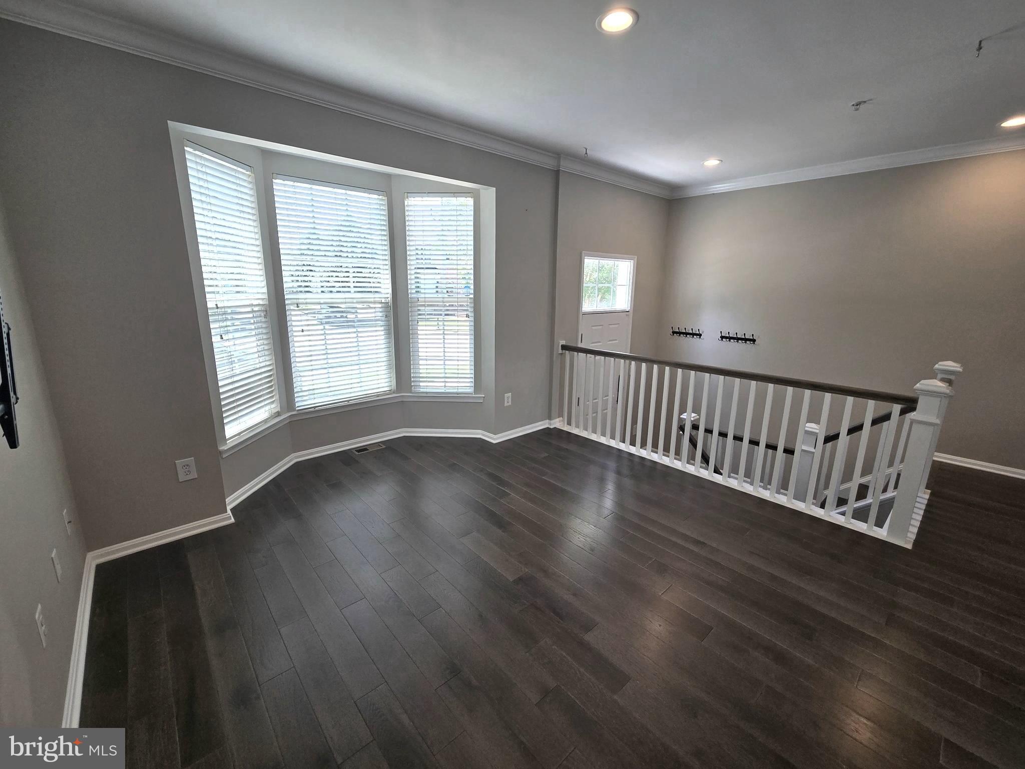 11847 Skylark Road Clarksburg, MD 20871 - Photo 3 of 46 a view of an empty room with wooden floor and a window