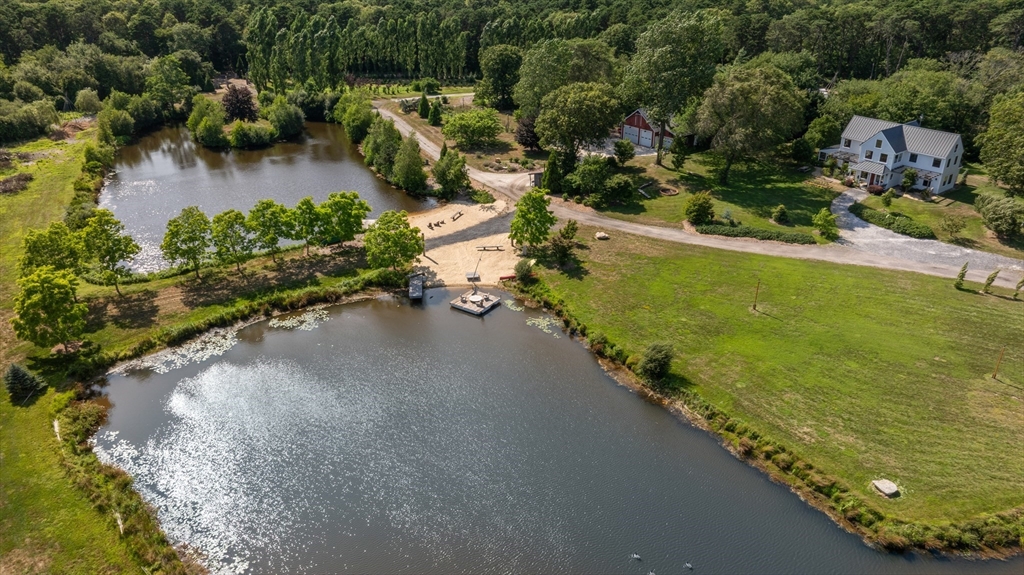 46 Roos Road Sandwich, MA 02537 - Photo 13 of 28 an aerial view of a house with a yard and lake view